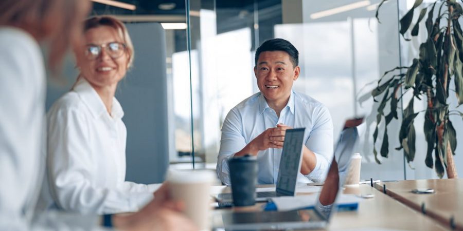 young-asian-businessman-listening-his-colleagues-meeting-modern-office